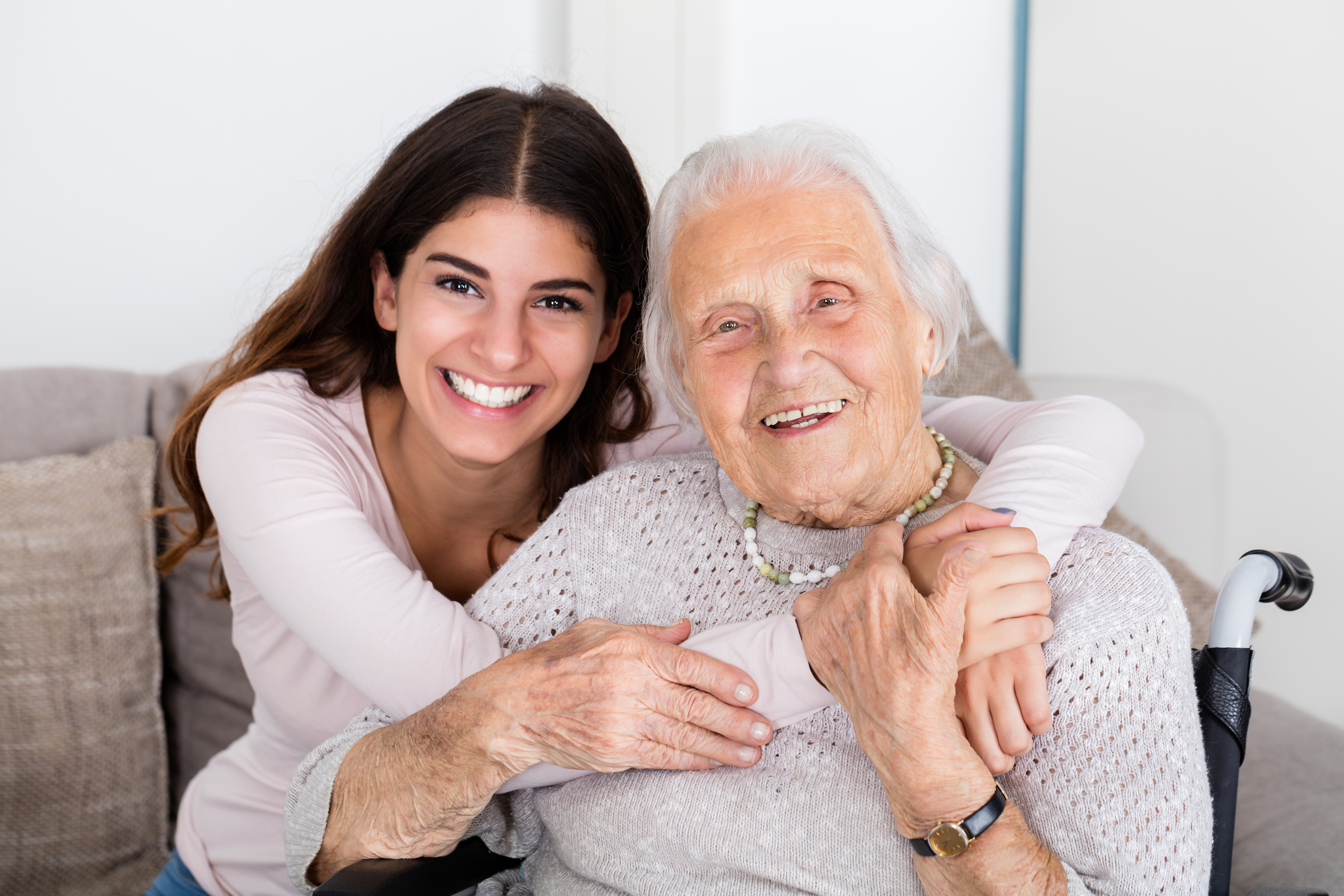 Portrait Of Happy Grandmother And Daughter Embracing Each Other At Home